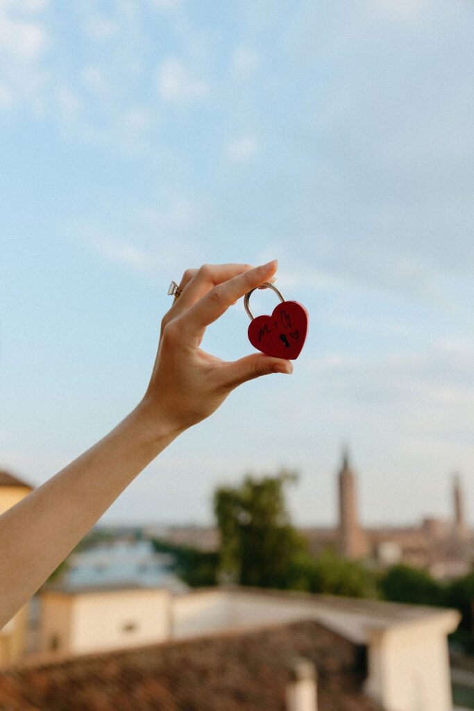 Woman lifting up the heart locket in Verona, Italy 