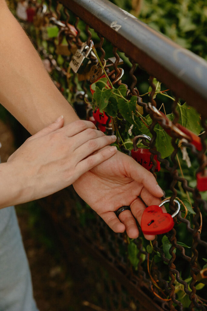 Man and woman put a lock on the gate in Verona, Italy 