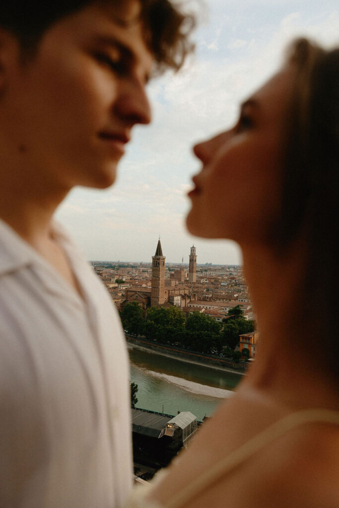 A closeup of the historic Verona, Italy backdrop between a man and woman's face