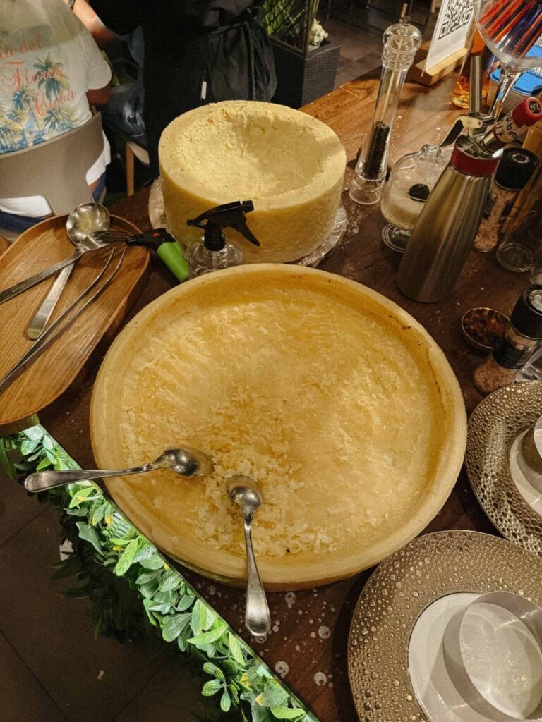 Italian pasta being prepared in a cheese wheel in Venice