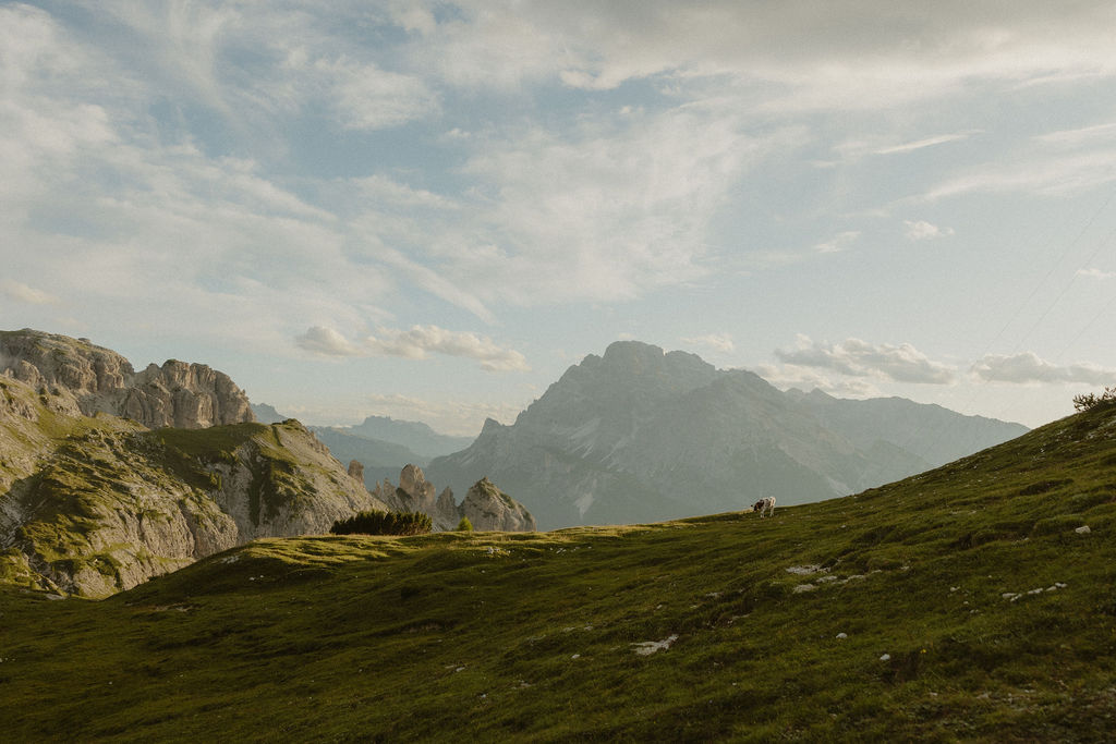 Golden hour illuminating rolling hills in the Dolomites, part of the best places to visit in the Dolomites