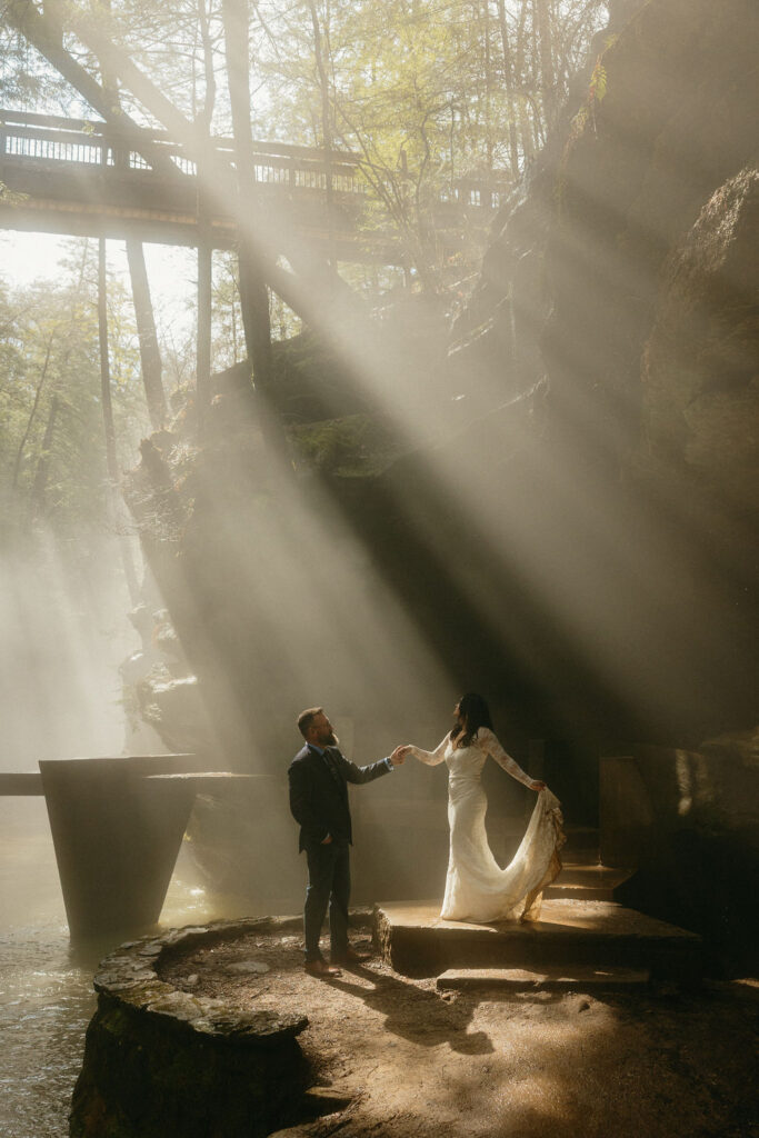 Couple standing on a foggy bridge in Hocking Hills for their elopement
