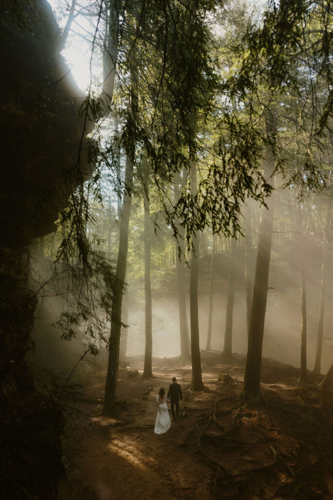 Couple exploring trails at Upper Falls during their adventurous Hocking Hills elopement