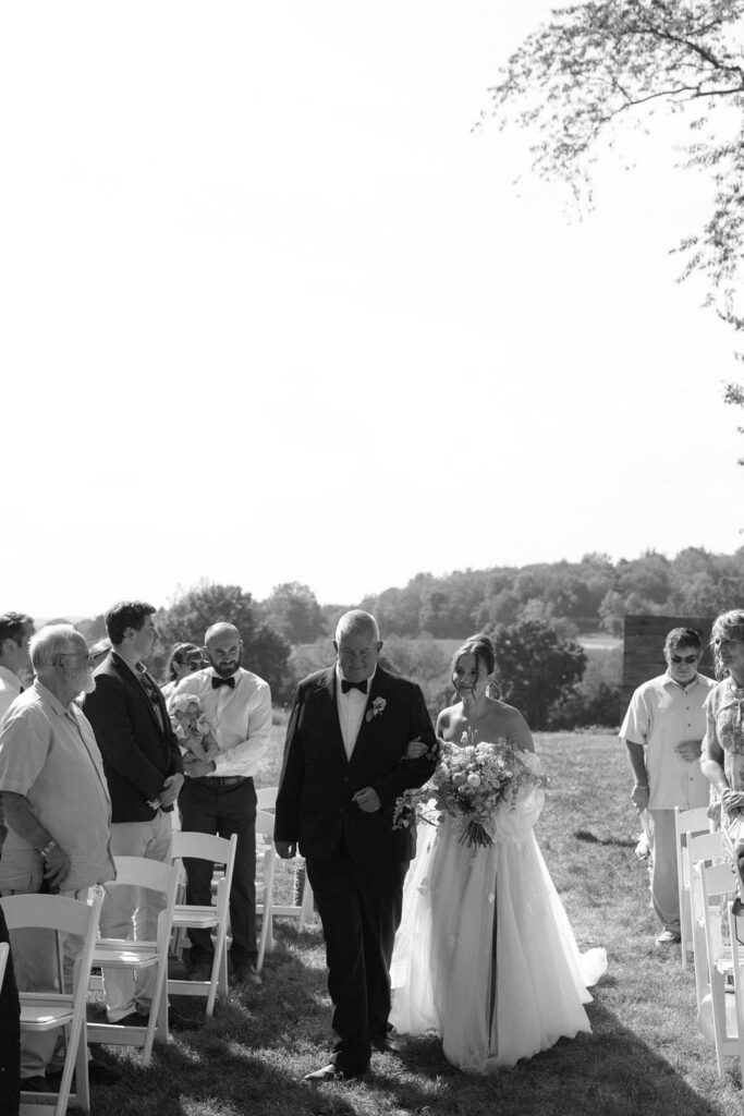 Bride walking down the aisle at her Magnolia Spring Farm wedding 