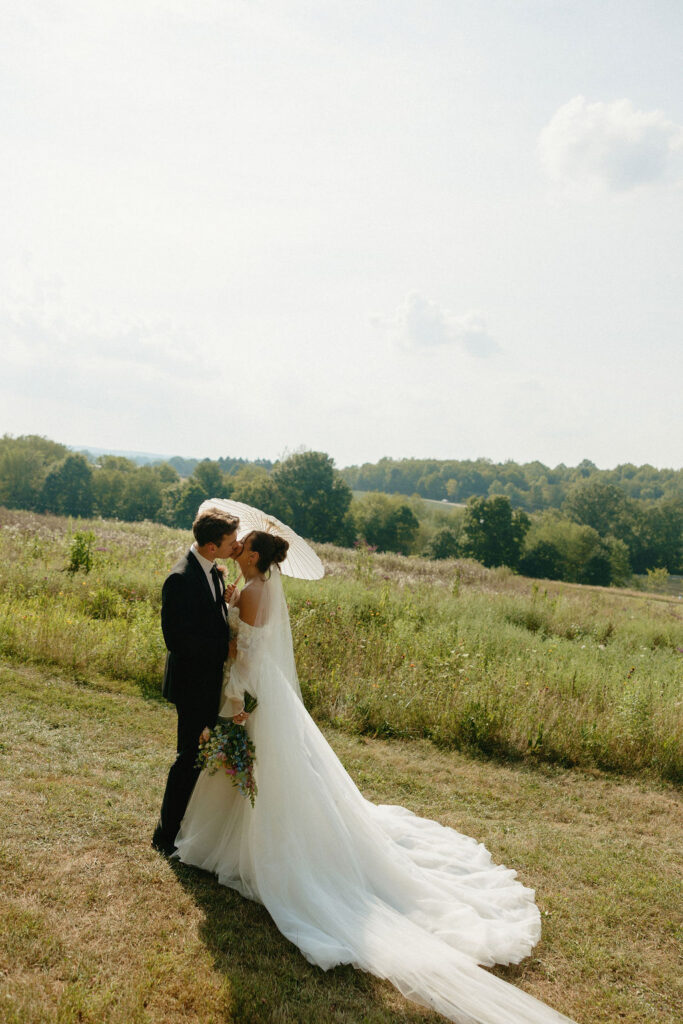 Bride and groom kissing during their Magnolia Spring Farm wedding portraits