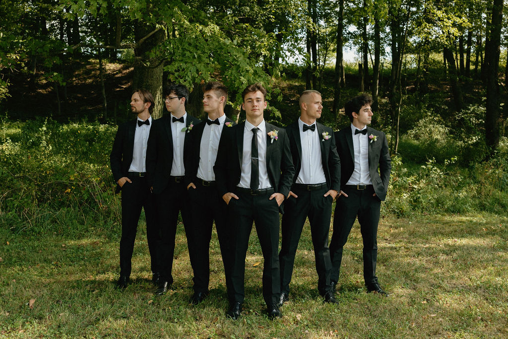 Groomsmen posing for a portrait before their Magnolia Spring Farm ceremony