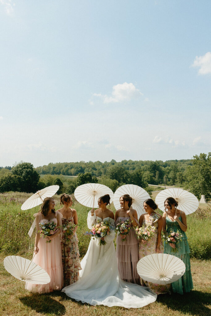 Mix matched bridesmaid dresses with parasols at Magnolia Spring Farm
