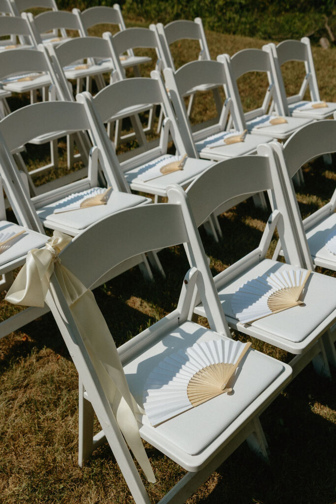 Paper fans on ceremony chairs for Ohio wedding