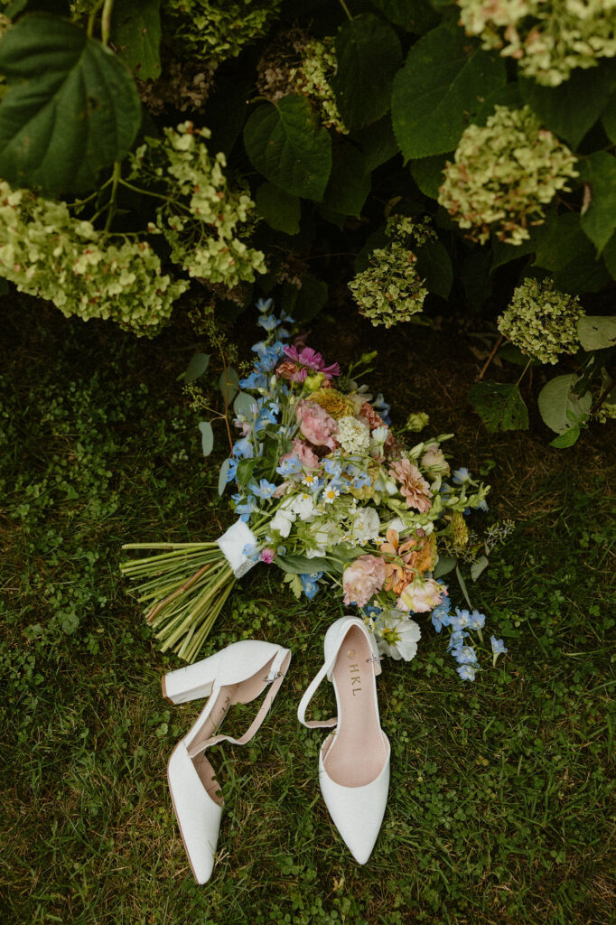 Bridal shoes laying on the grass at Magnolia Spring Farm