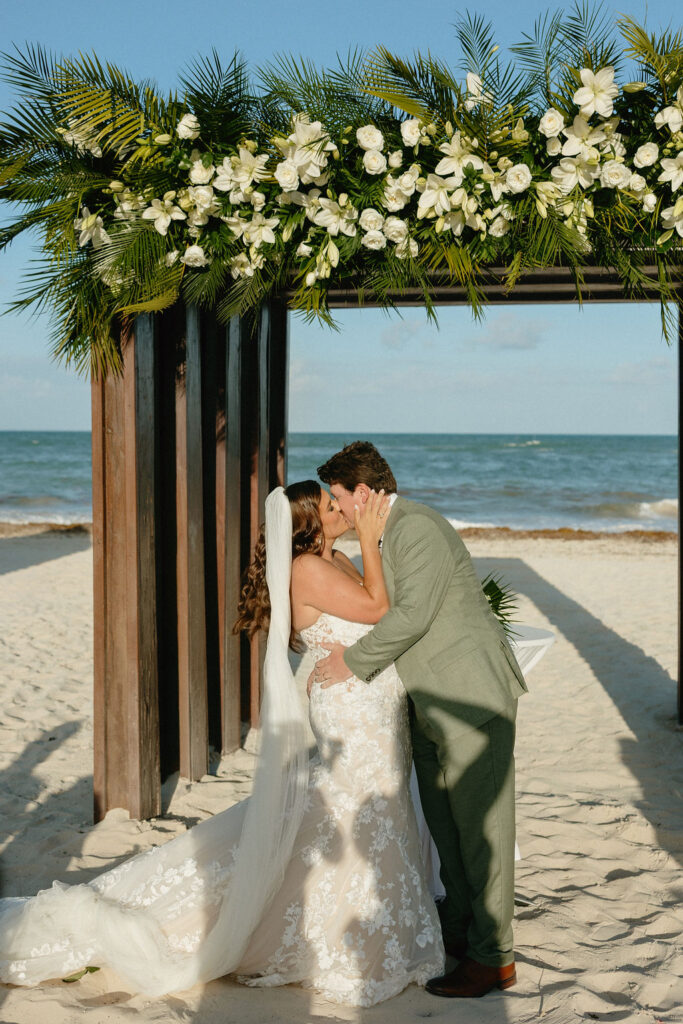 Couples wedding kiss on the beach at Secrets Playa Blanca 