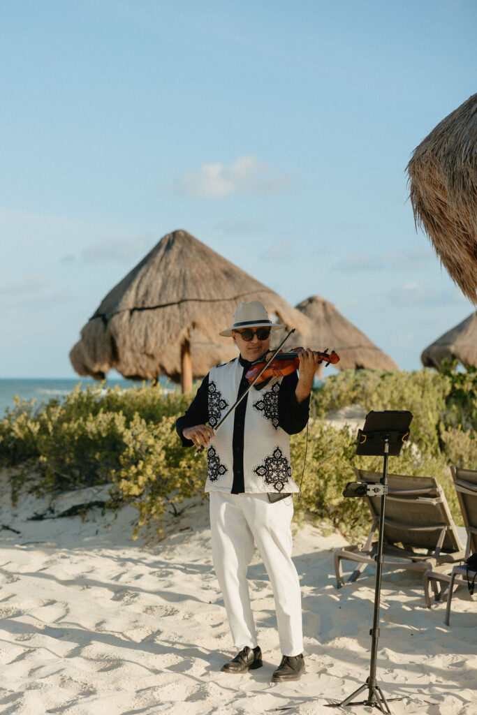 Musician playing a violin during a ceremony at Secrets Playa Blanca
