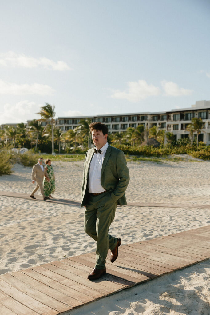Groom walking down the aisle for his ceremony at Secrets Playa Blanca in Cancun