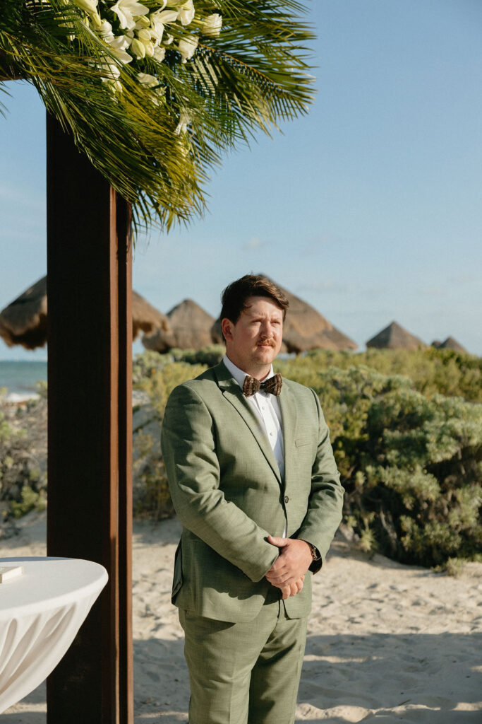 Groom watching his bride walk down the aisle for their ceremony at Secrets Playa Blanca. 