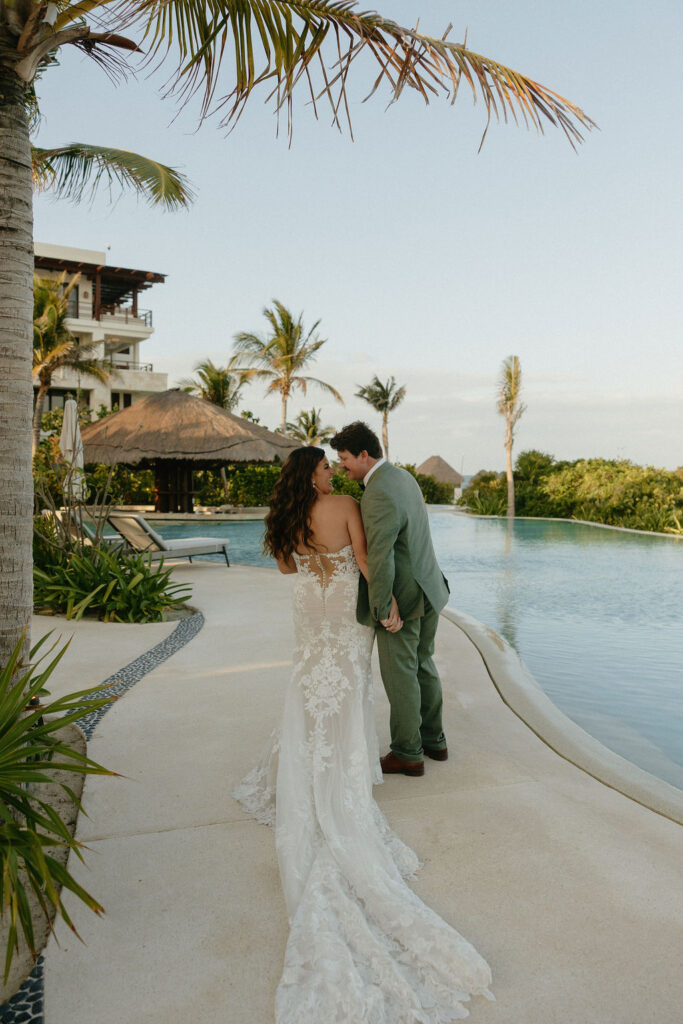 Couple smiling at each other by the pool at Secrets Playa Blanca