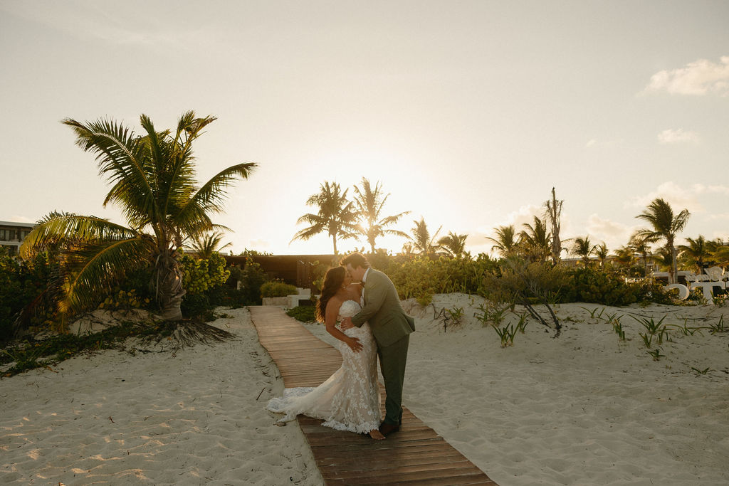 Sunset beach portraits of a couple kissing at Secrets Playa Blanca
