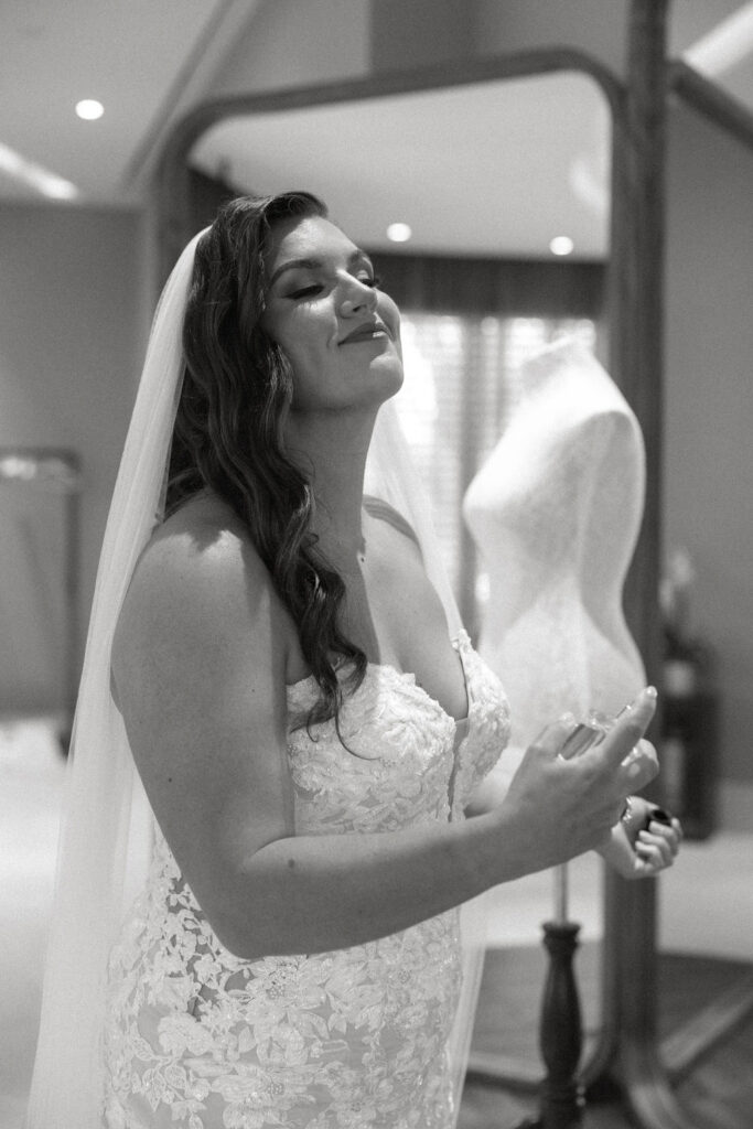 Bride putting on her perfume in Secrets Playa Blanca's bridal suite
