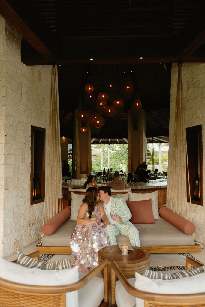 Bride and groom kissing at a bar in Secrets Playa Blanca