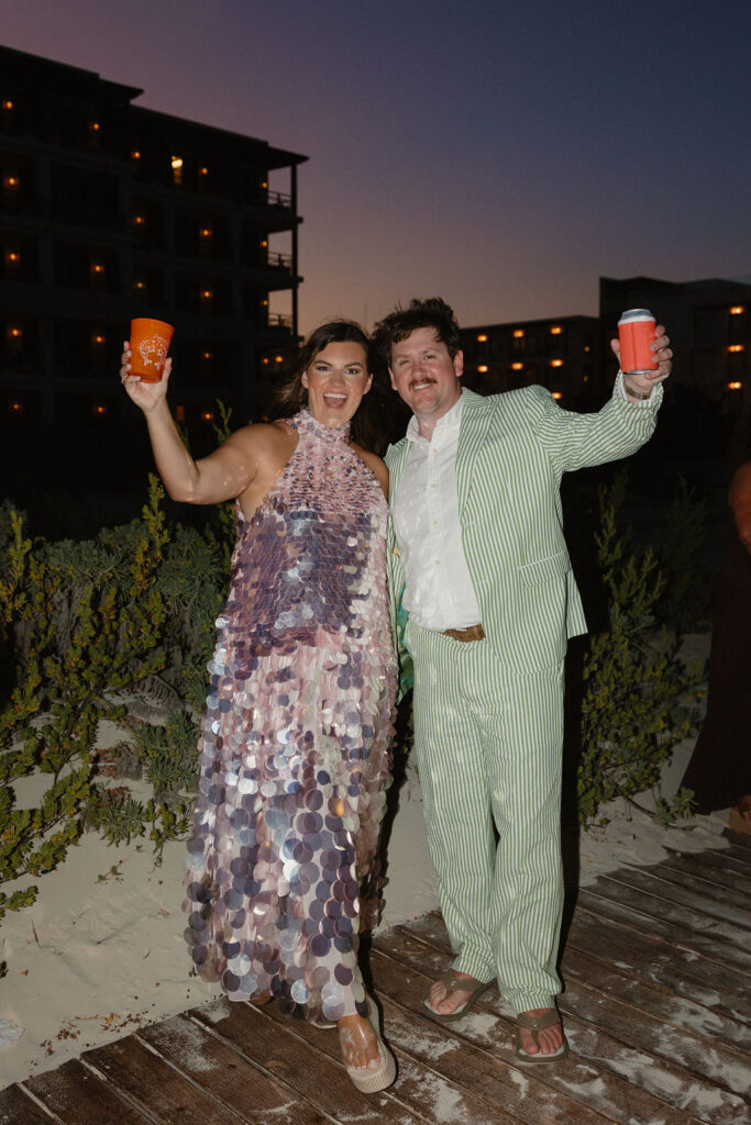 Couple cheering during sunset 