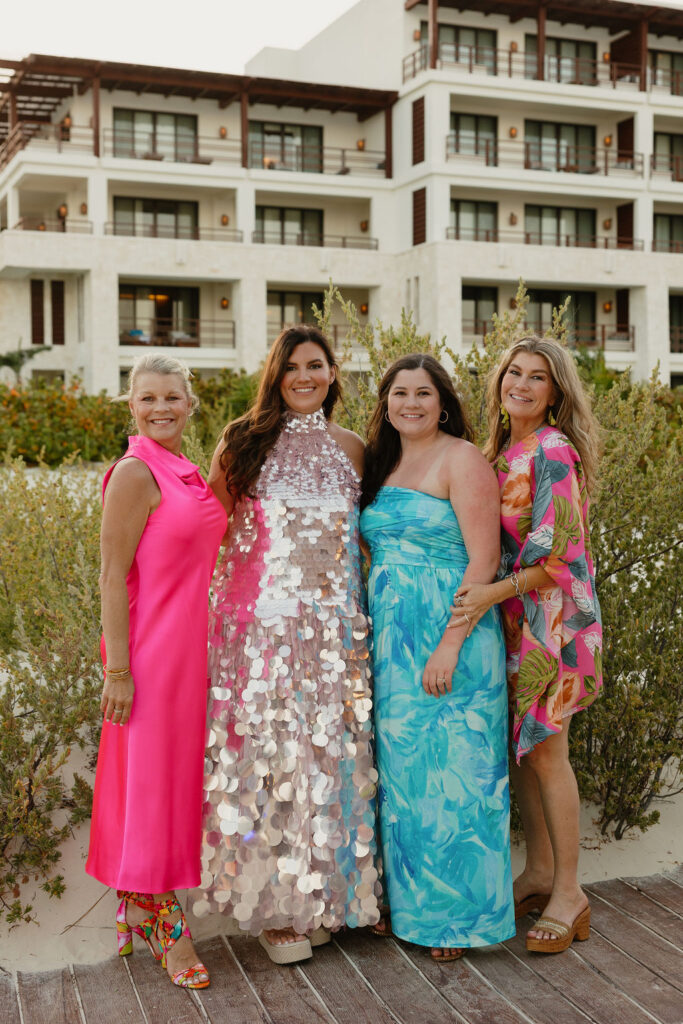 Bride and family taking a photo together on the beach 