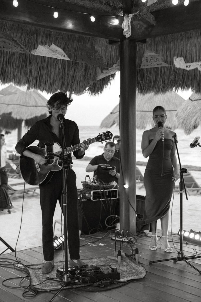 Live music being performed under the palapa at Secrets Playa Blanca 